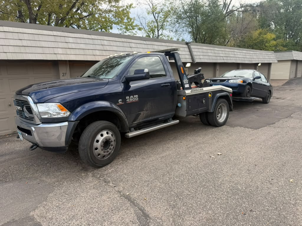 Twins Towing truck towing a sedan